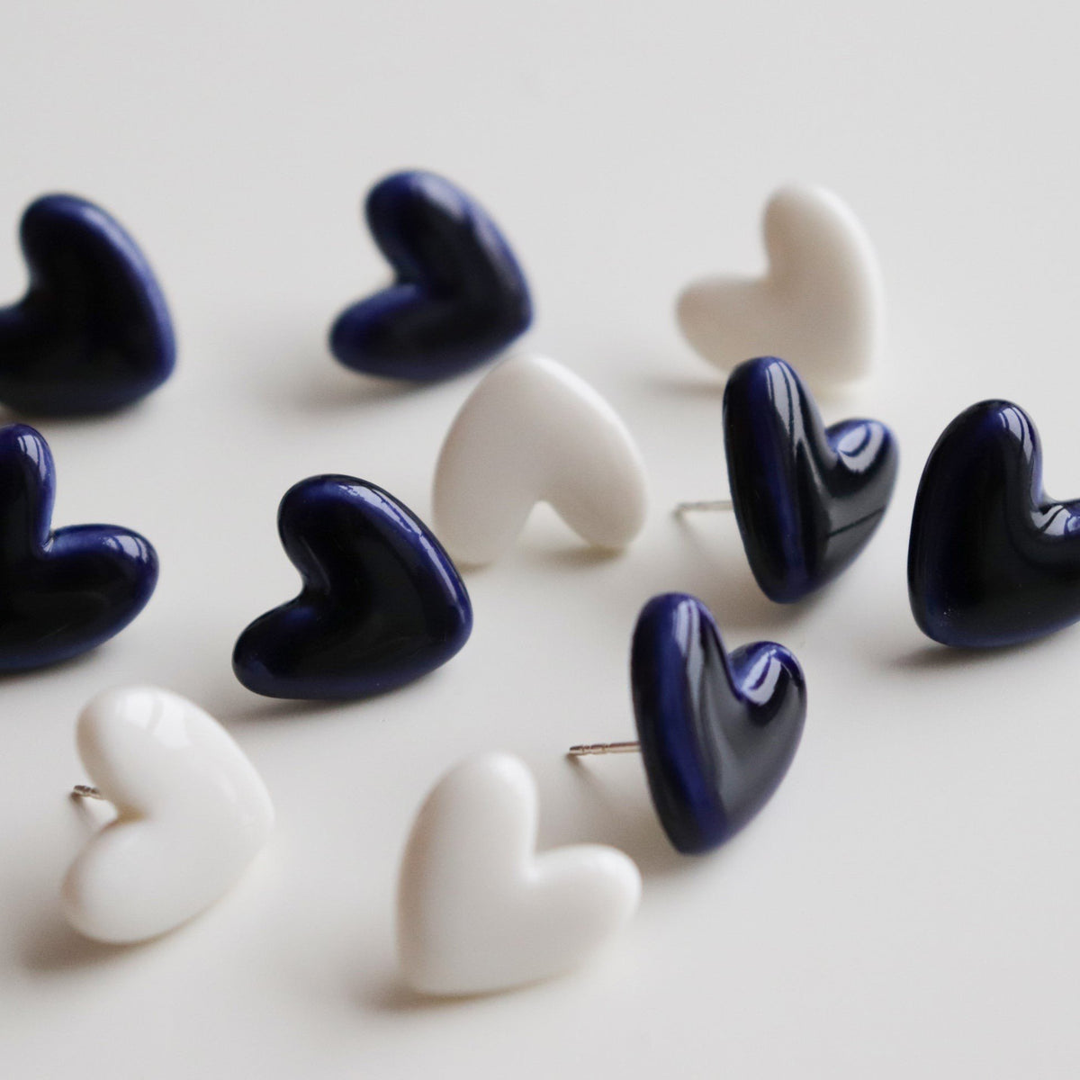 4. Assorted Rozenthal heart studs in white and navy, showcasing variety in design