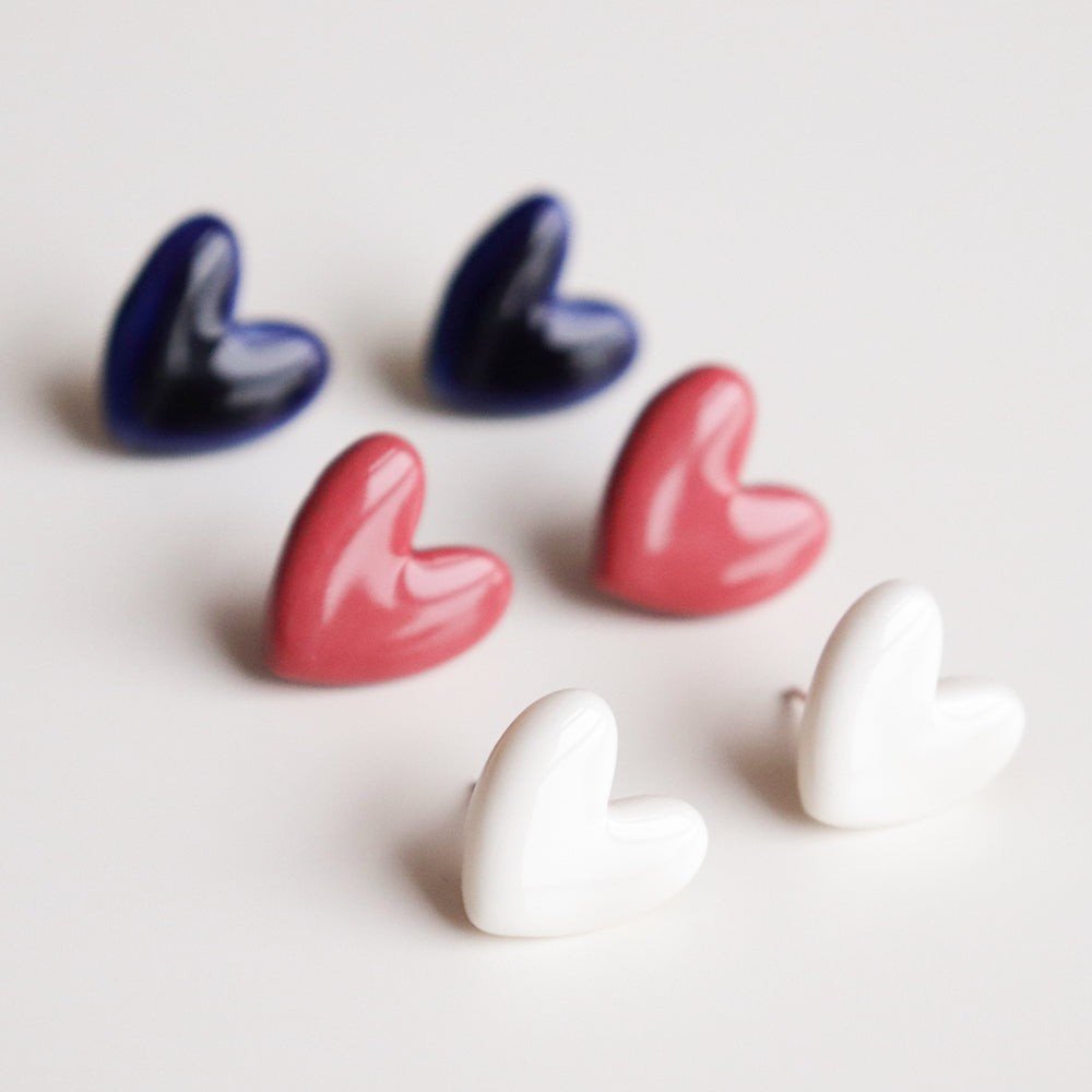 6. Assorted Rozenthal heart studs in white, red, and navy, highlighting color options