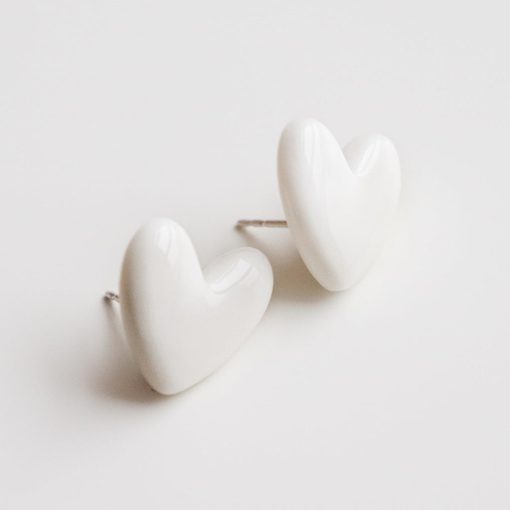2. Close-up of Rozenthal Porcelain Heart Studs in white, highlighting high-quality porcelain and sterling silver posts