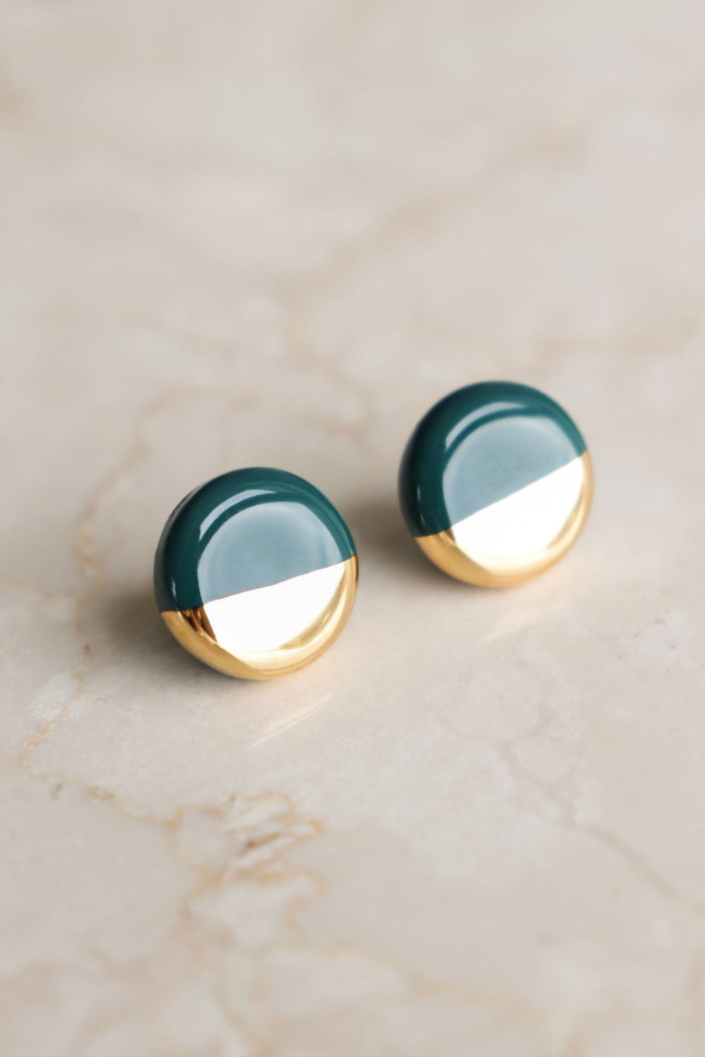3. Studio shot of Rozenthal Porcelain Round Stud Earrings in green and gold on marble surface
