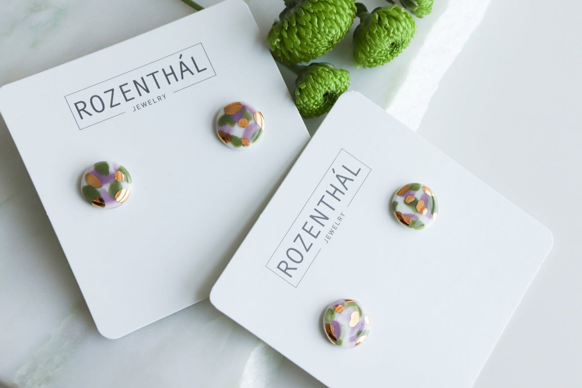 3. Rozenthal Porcelain Tache Studs in green and violet displayed on branded jewelry cards