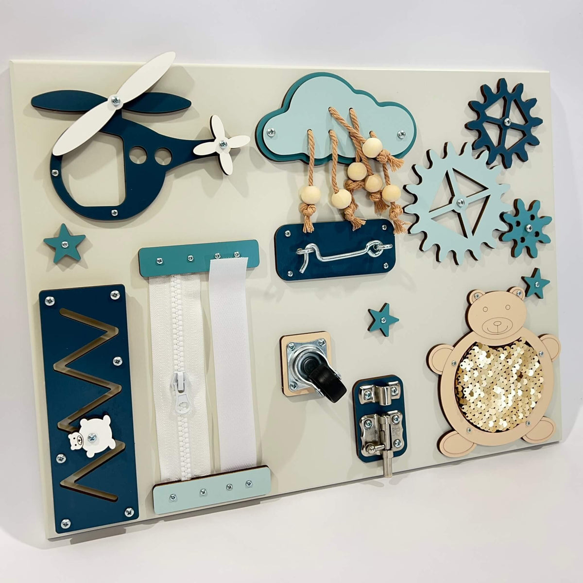 2. Portable baby sensory busy board with blue and beige elements including a helicopter, cloud, and bear on a white background