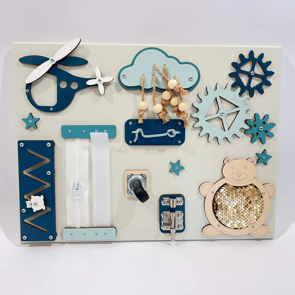 2. Portable baby sensory busy board featuring blue and beige elements like a helicopter, cloud, and bear on a white background
