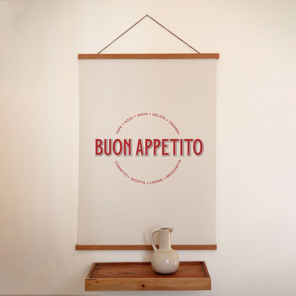1. Minimalist Buon Appetito poster with red Italian typography hanging on a white wall above a wooden shelf with a ceramic jug, creating a rustic interior vibe