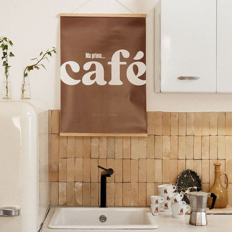 2. Cafe poster with Italian text hanging in a kitchen above a sink with cups and a coffee maker