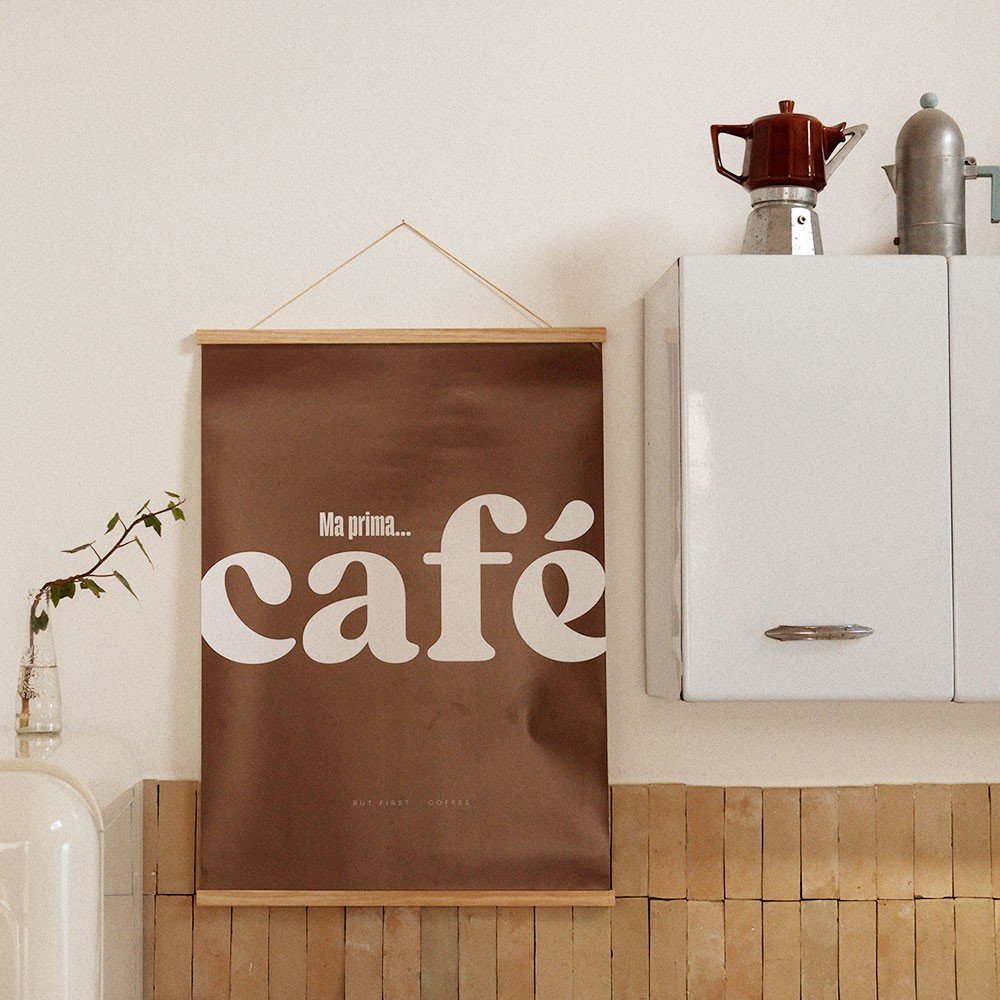 3. Italian Cafe poster hanging in a kitchen next to white cabinets and a coffee pot