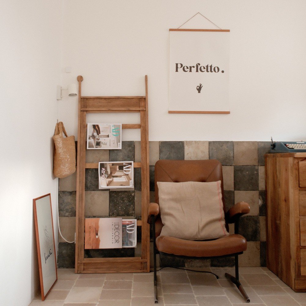 2. Perfetto poster in a cozy room setting with a leather chair, wooden ladder, and tiled wall