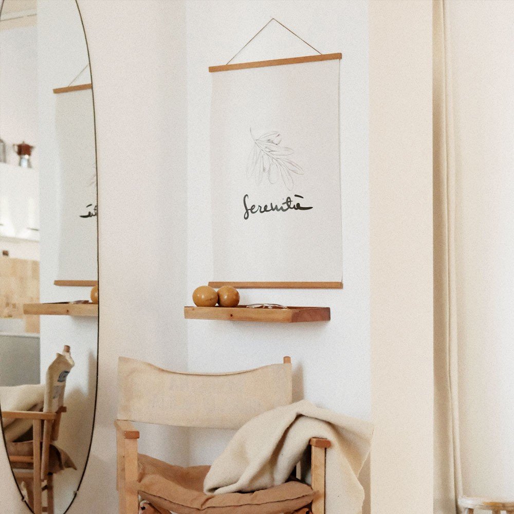1. Terra Mamma Serenita poster with minimalist design and Italian typography hanging in a cozy room with a mirror and wooden chair