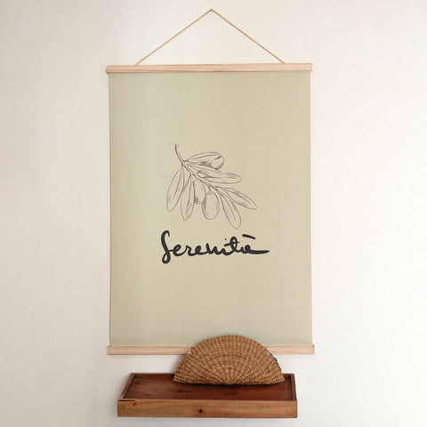 2. Terra Mamma Serenita poster with olive branch sketch and Italian typography on a light background, hanging above a wooden shelf