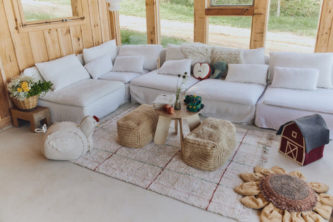 1. Living room with Lorena Canals Pouf Haystacks in light honey, paired with white sofas and rustic decor, creating a warm, inviting space