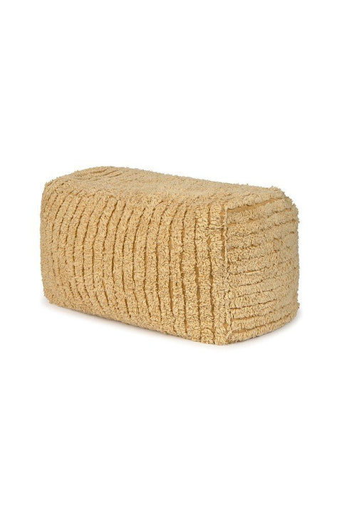 2. Studio shot of Lorena Canals Pouf Haystack in light honey color, showcasing its rectangular shape and soft cotton texture