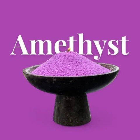 2. Amethyst powdered candle sand in black bowl with visible wick on purple background