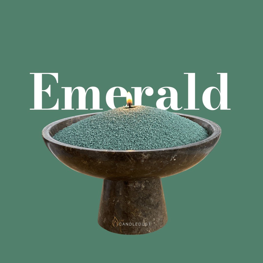 1. Candledust emerald powdered candle in a decorative bowl with a lit wick on a green background
