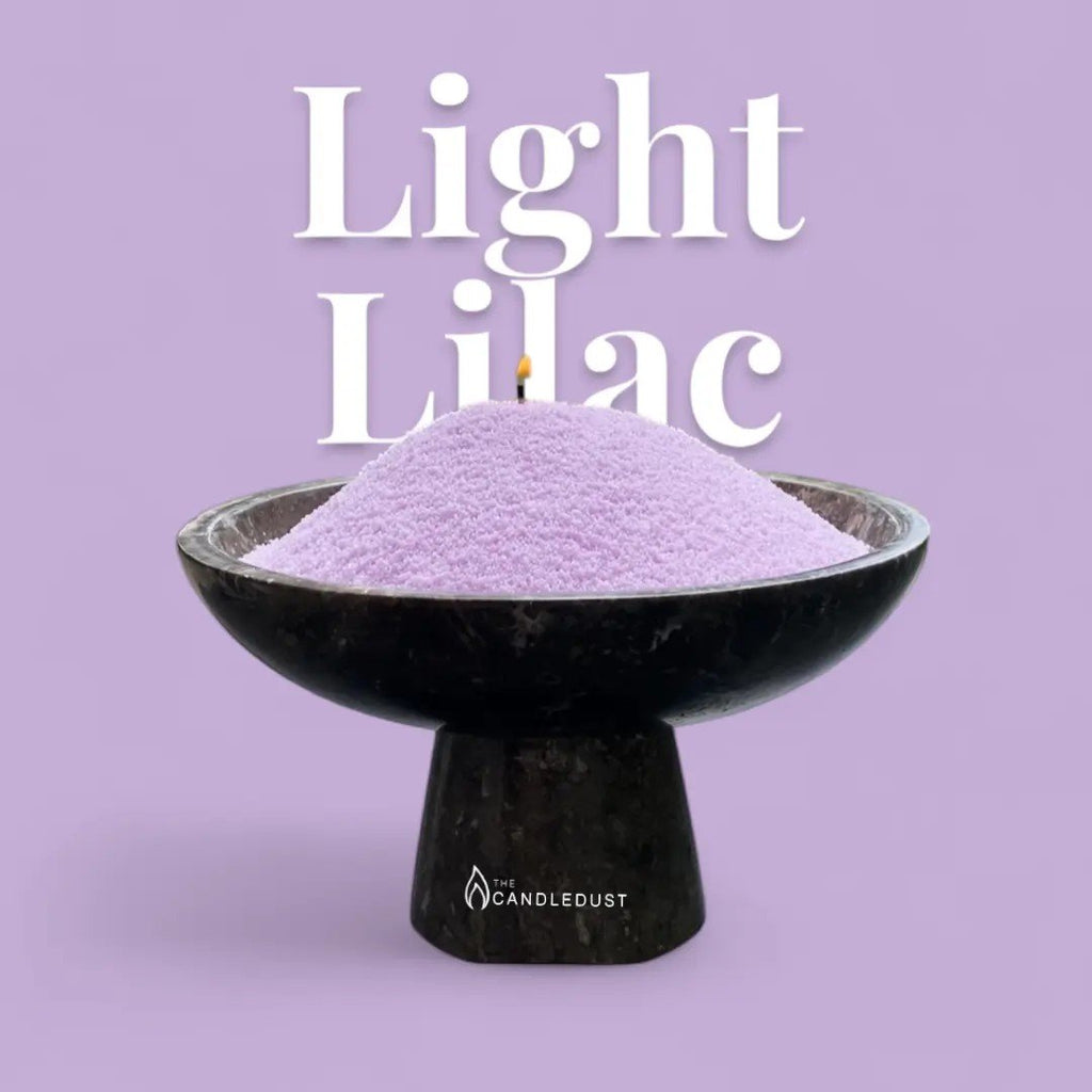 2. Light lilac candle sand in a black bowl with a wick, set against a matching lilac background with text