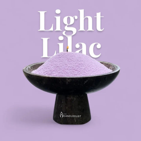 2. Light lilac candle sand in a black bowl with a wick, set against a matching lilac background with text