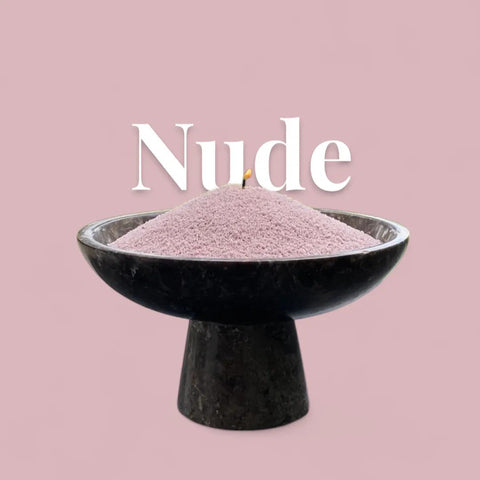 3. Nude candle sand in black pedestal bowl with lit wick and 'Nude' text on pink background