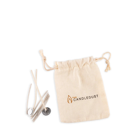 3. Candledust kit with wicks and a branded drawstring bag on a white background