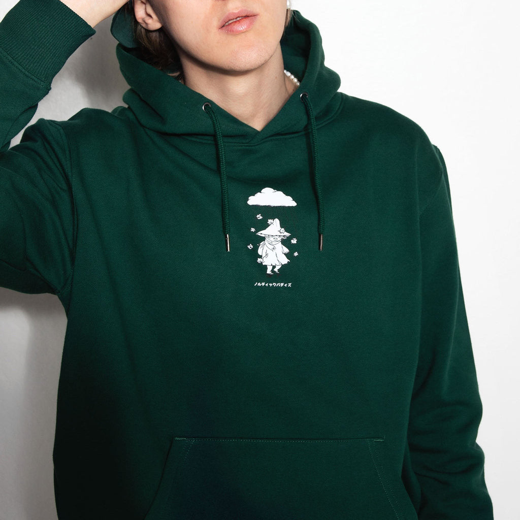 1. Male model wearing green unisex hoodie with Moomin character print, hand on head, in studio setting