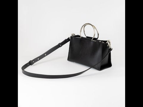 ✨ Ever wondered how chic meets function? Unleash your elegance with the PYKOK Maria Mini. This little black wonder is just the right size for your essentials, with an adjustable strap to keep things hands-free and stylish. From metal handles to a chic chain strap, every detail whispers luxury. Elevate your look—whether it's for the shoenight or a busy day on the move. Ready to turn heads? See more via the link in bio. crossbodybag