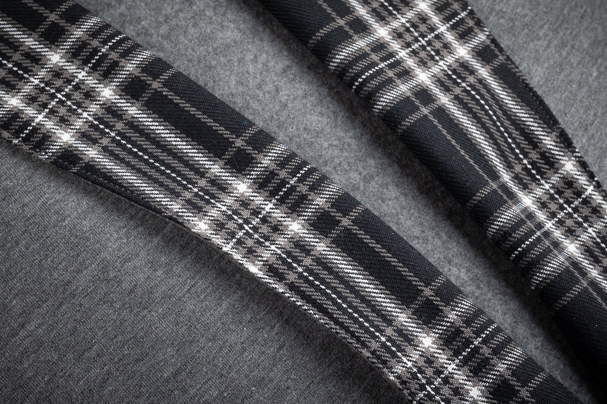 1. Close-up of black-and-white checkered flannel detail on gray cotton fleece fabric of Prii robe