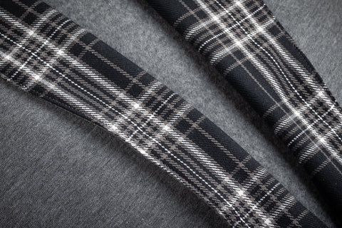 1. Close-up of black-and-white checkered flannel detail on gray cotton fleece fabric of Prii robe