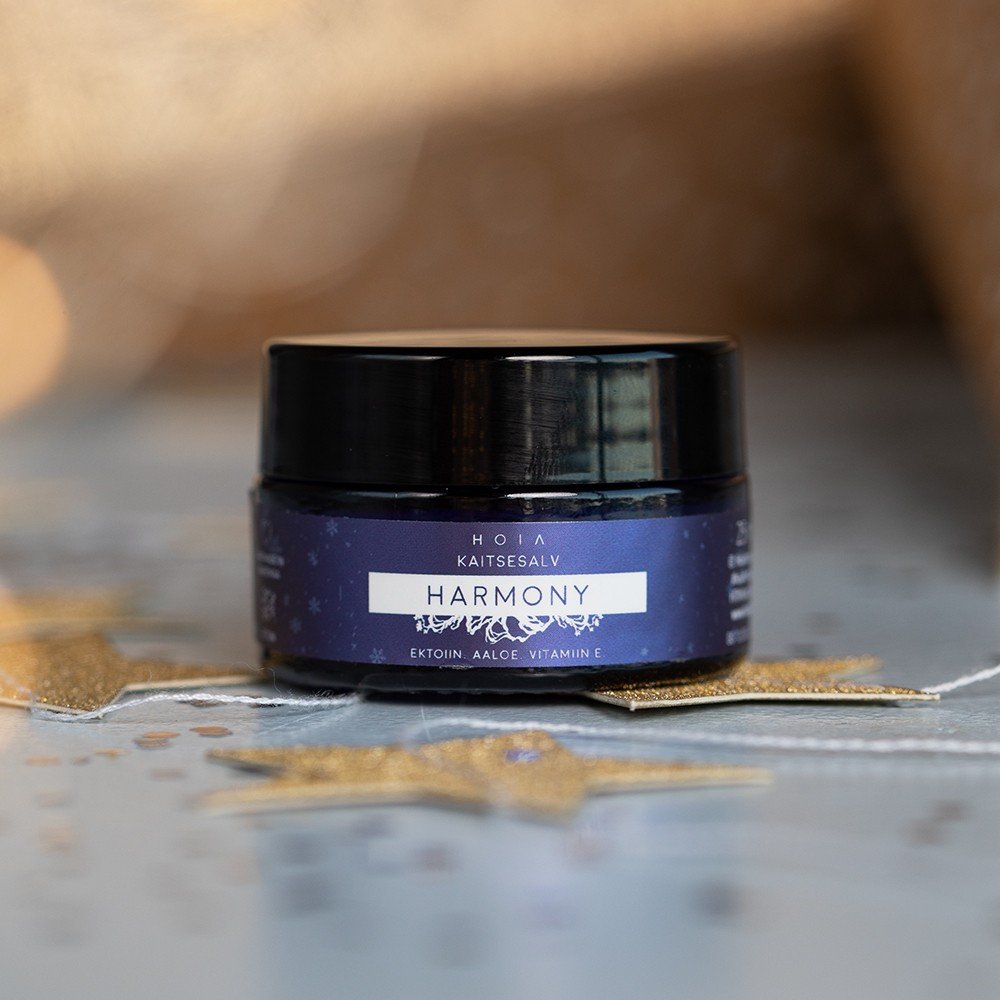 1. HOIA homespa Protective Balm Harmony in a dark jar with blue label, featuring ectoine, aloe, and vitamin E, placed on a decorative surface with golden stars