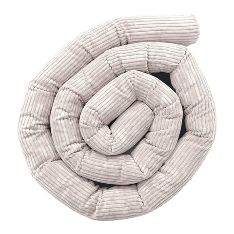 1. Ecru protective roll bumper for baby crib made of soft corduroy fabric, coiled in a spiral shape, showcasing texture and design