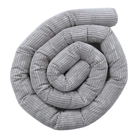 1. Grey protective roll bumper for baby crib made from soft corduroy fabric, coiled in a spiral shape, highlighting texture and design