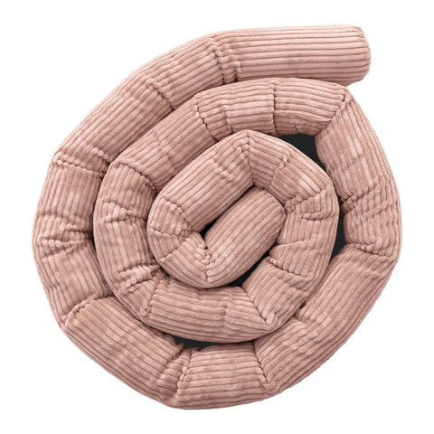 1. Powder pink protective roll bumper for baby crib made of soft corduroy fabric, coiled in a spiral shape, highlighting texture and design