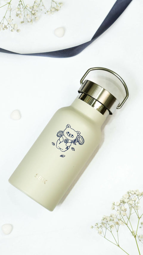 1. SEIK beige stainless steel water bottle with cute bear design, shown in lifestyle setting