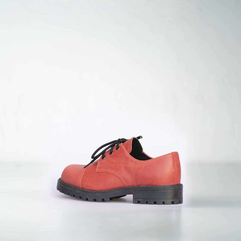 2. Side view of unisex red leather sneakers by Samelin, featuring black laces and durable outsole in studio