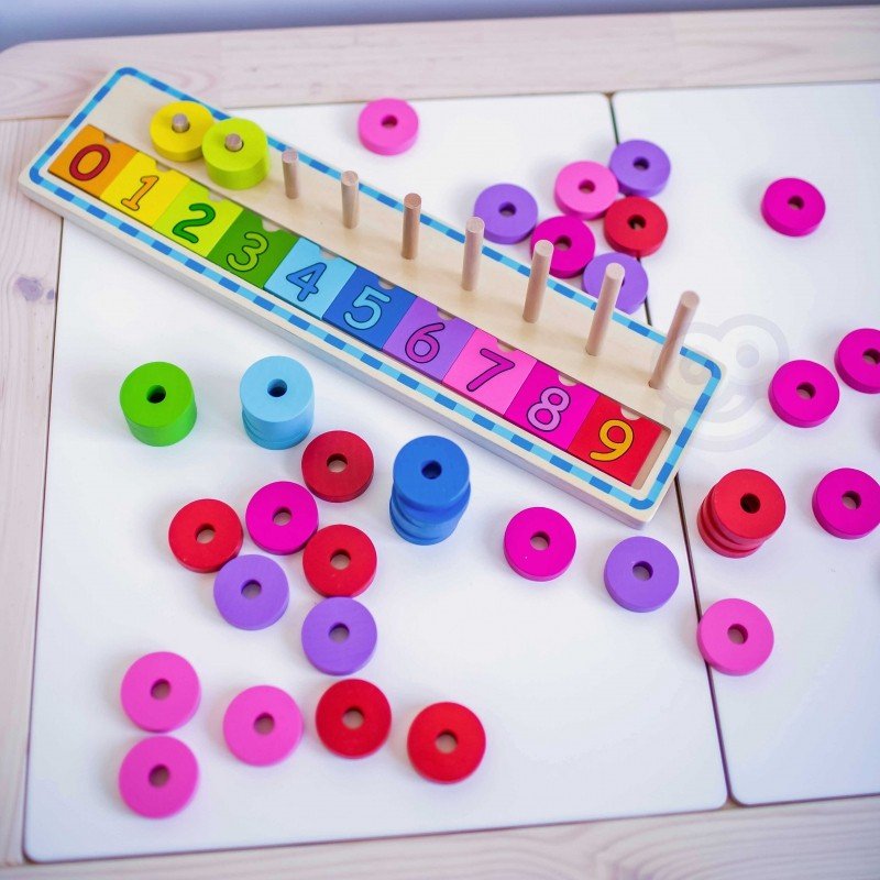 3. Colorful wooden counting puzzle with scattered rings on a white table