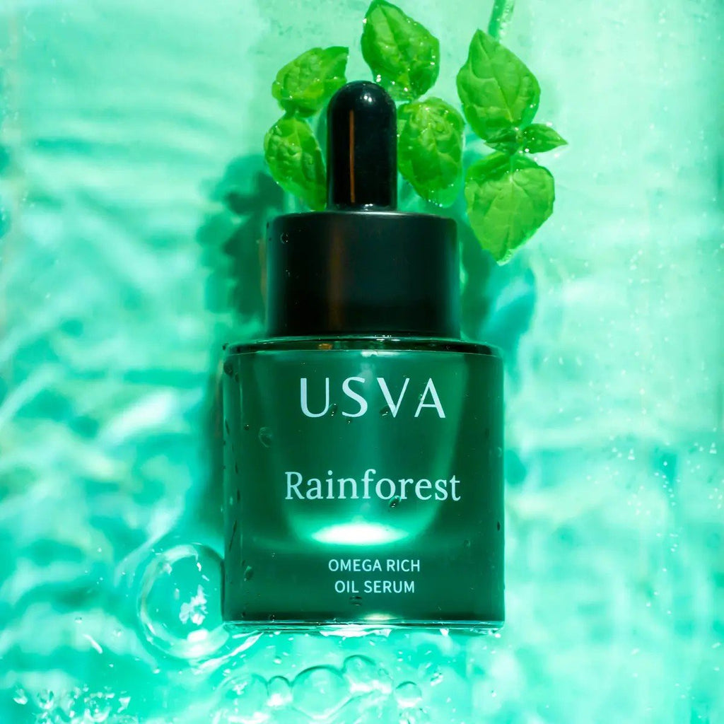 1. Usva Cosmetics Rainforest Omega Rich Oil Serum bottle with green leaves in water