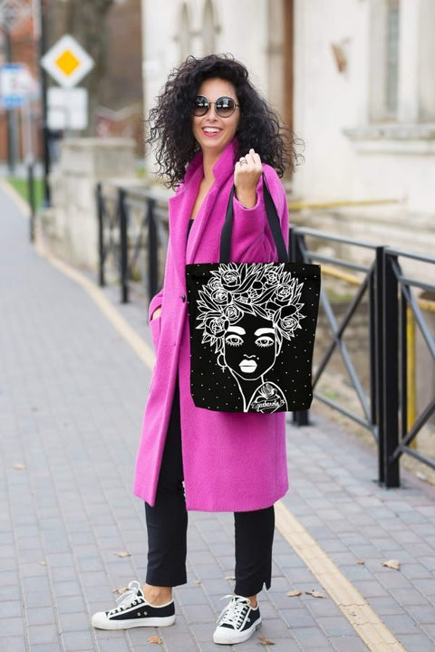 5. Woman in pink coat carrying Garbanota Naomi handbag with floral haircut design in black, street style