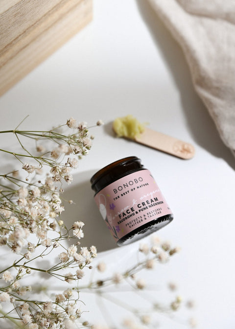 1. BONOBO Yarrow & Oregano Face Cream with juniper spatula, shown with floral accents