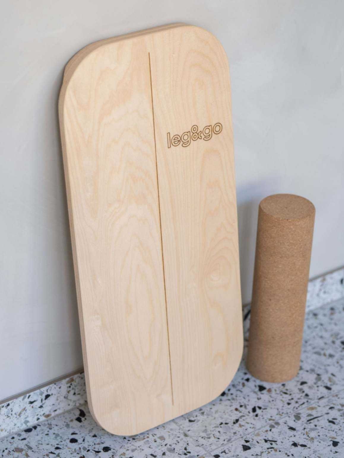 1. Rectangular balance board with cork roller featuring leg&go side logo on terrazzo floor