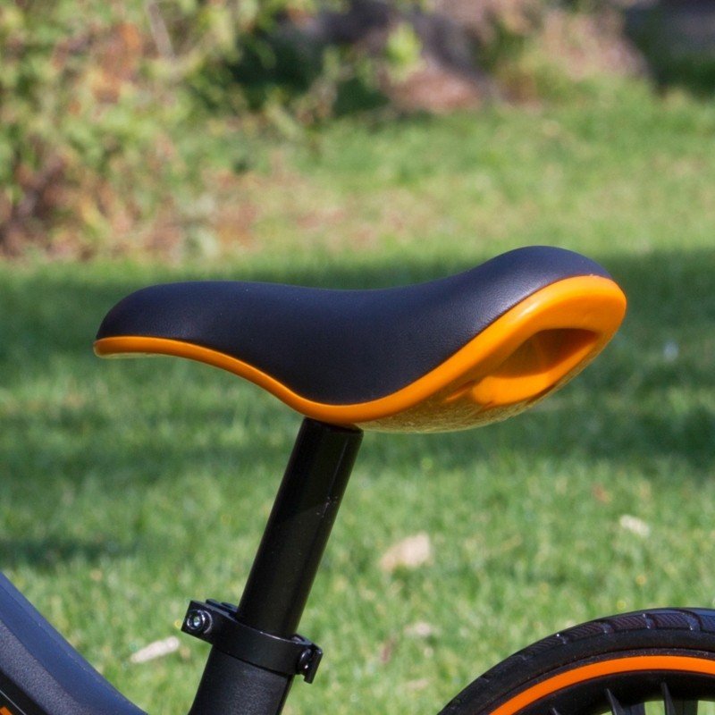 3. Close-up of black and orange saddle on Feber balance bike