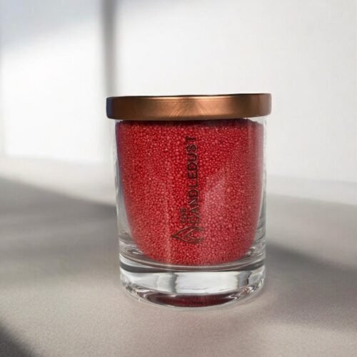 2. Red unscented powder candle by Candledust in glass with metal lid, shown in studio setting