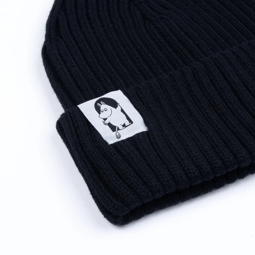 2. Close-up of black Moomin by NordicBuddies Red Cross Beanie, highlighting ribbed texture and Moomin character patch