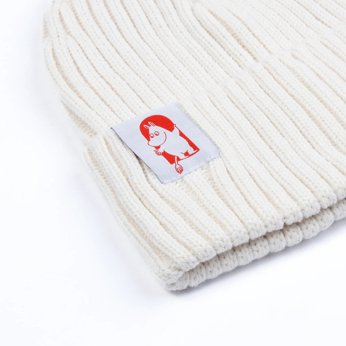 2. Close-up of white Moomin by NordicBuddies Red Cross Beanie, highlighting Moomin character patch and ribbed texture