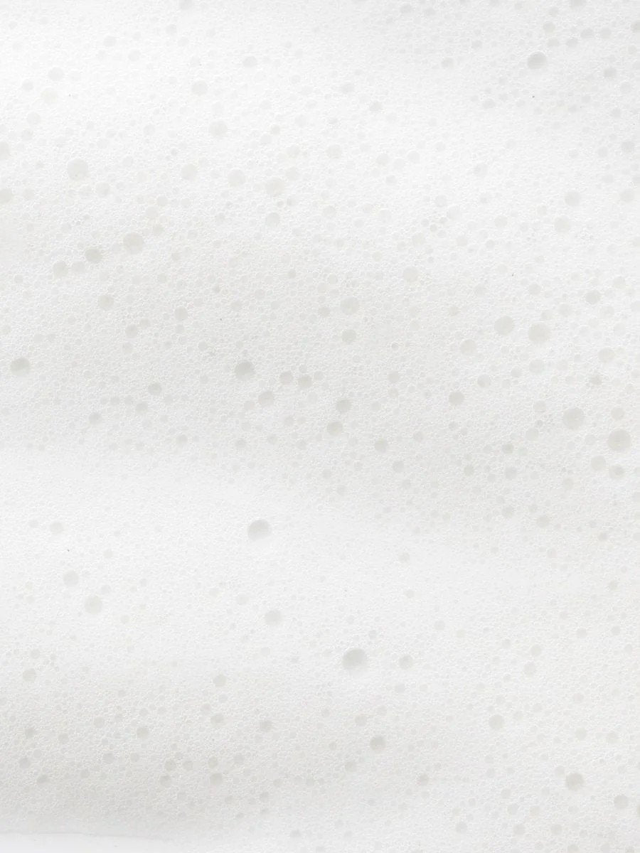 4. Close-up of white foam texture, representing the lather of Magrada rhubarb shampoo