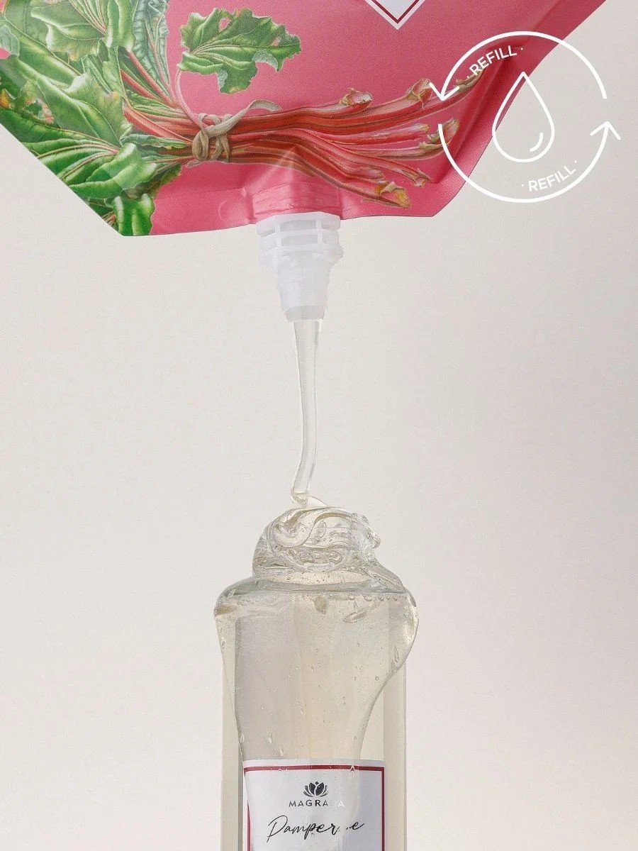 5. Magrada Organic Cosmetics rhubarb shampoo being poured from refill pack into bottle, emphasizing eco-friendly refill concept