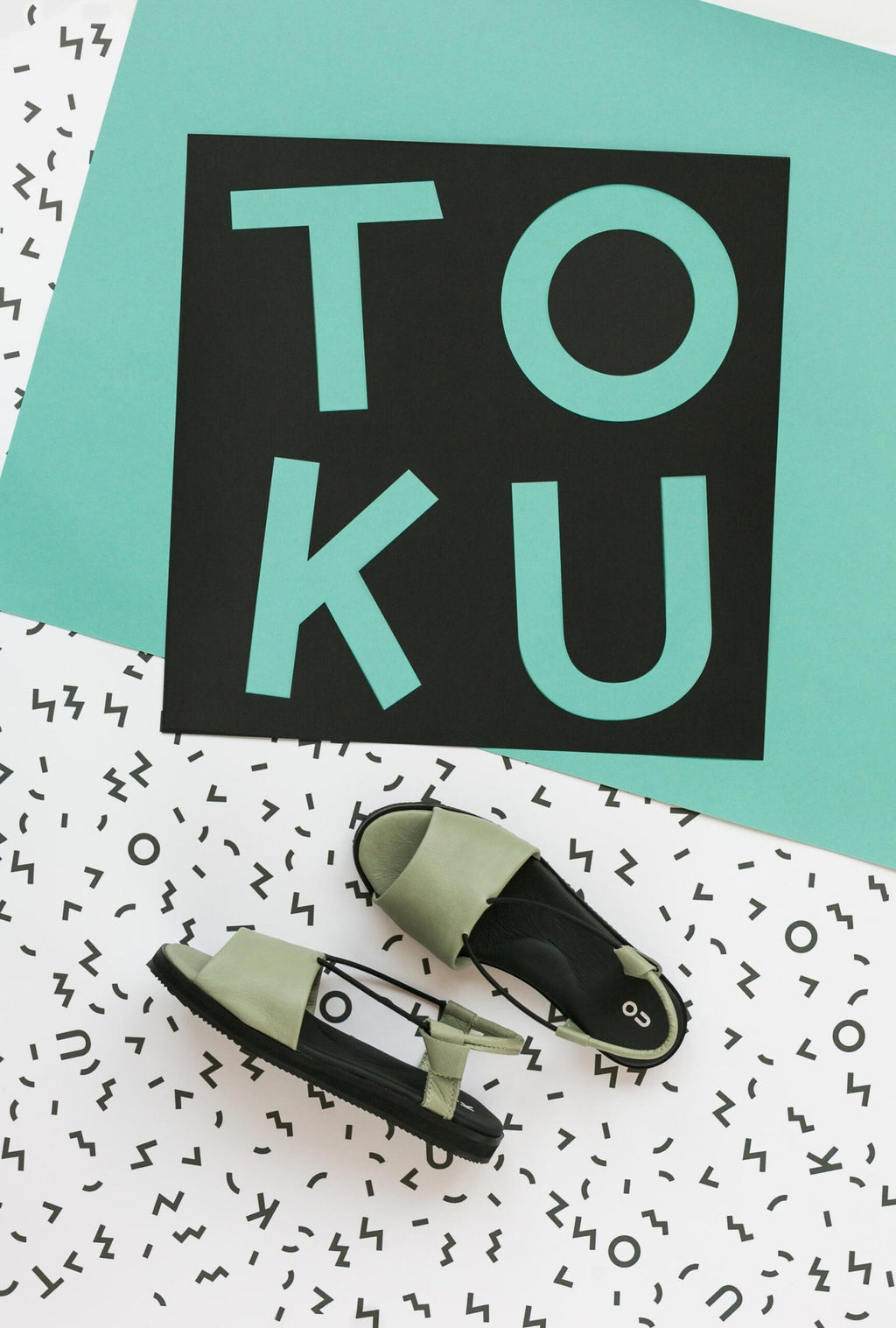 4. Flat lay of green Berlin sandals by Omaking with black insole, showcasing the ergonomic design