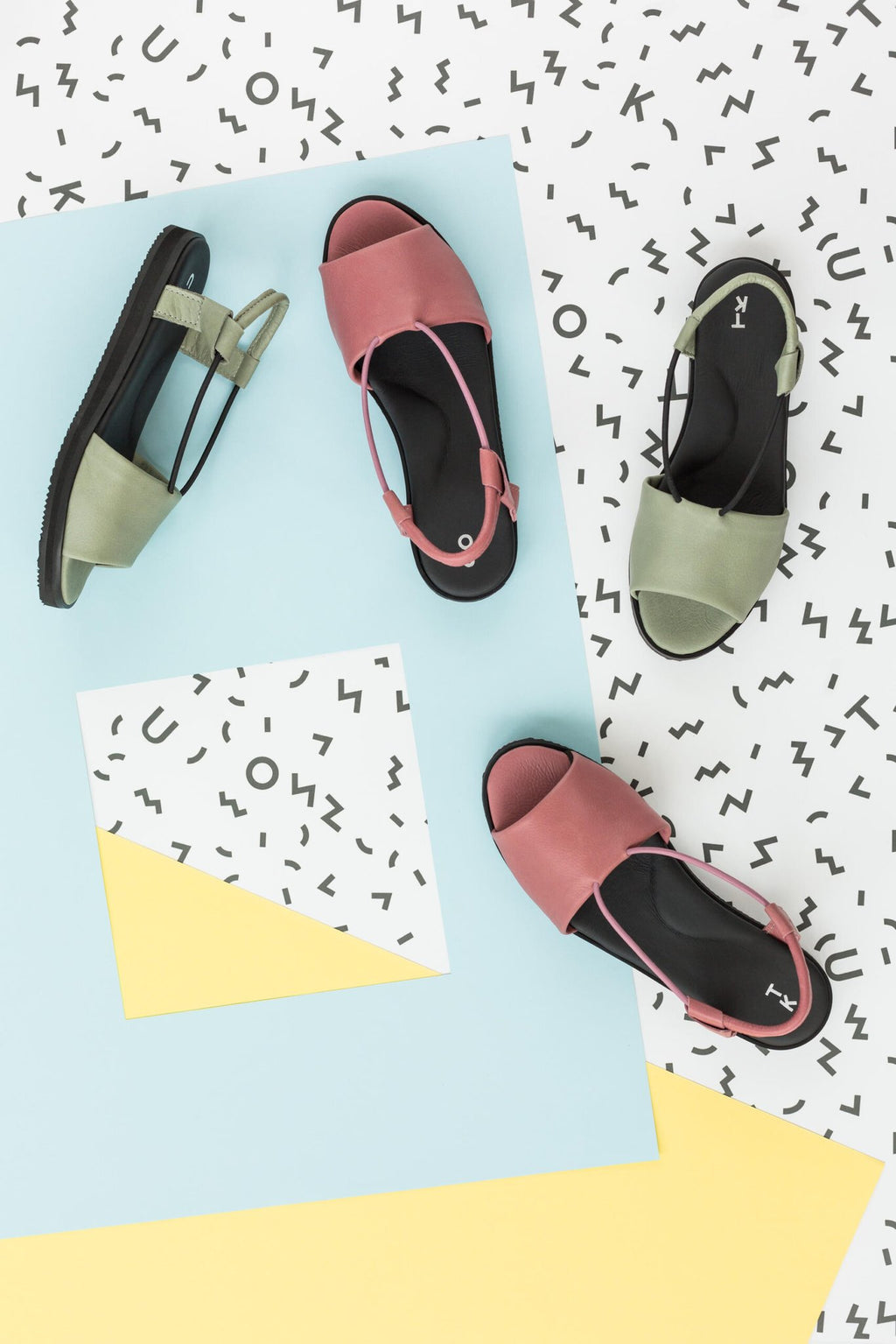 3. Green and pink Berlin sandals by Omaking arranged on a colorful abstract background