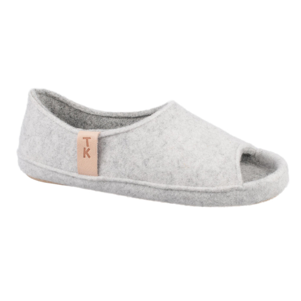 3. Side view of unisex TOKU Bern white slipper by Omaking, highlighting TK branding and breathable design