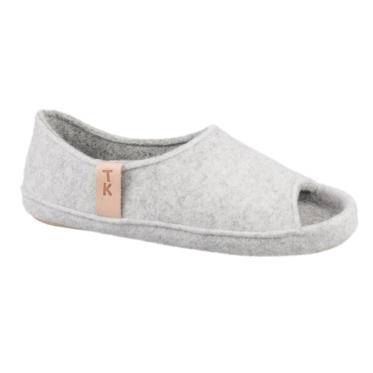 3. Side view of unisex TOKU Bern white slipper by Omaking, highlighting TK branding and breathable design