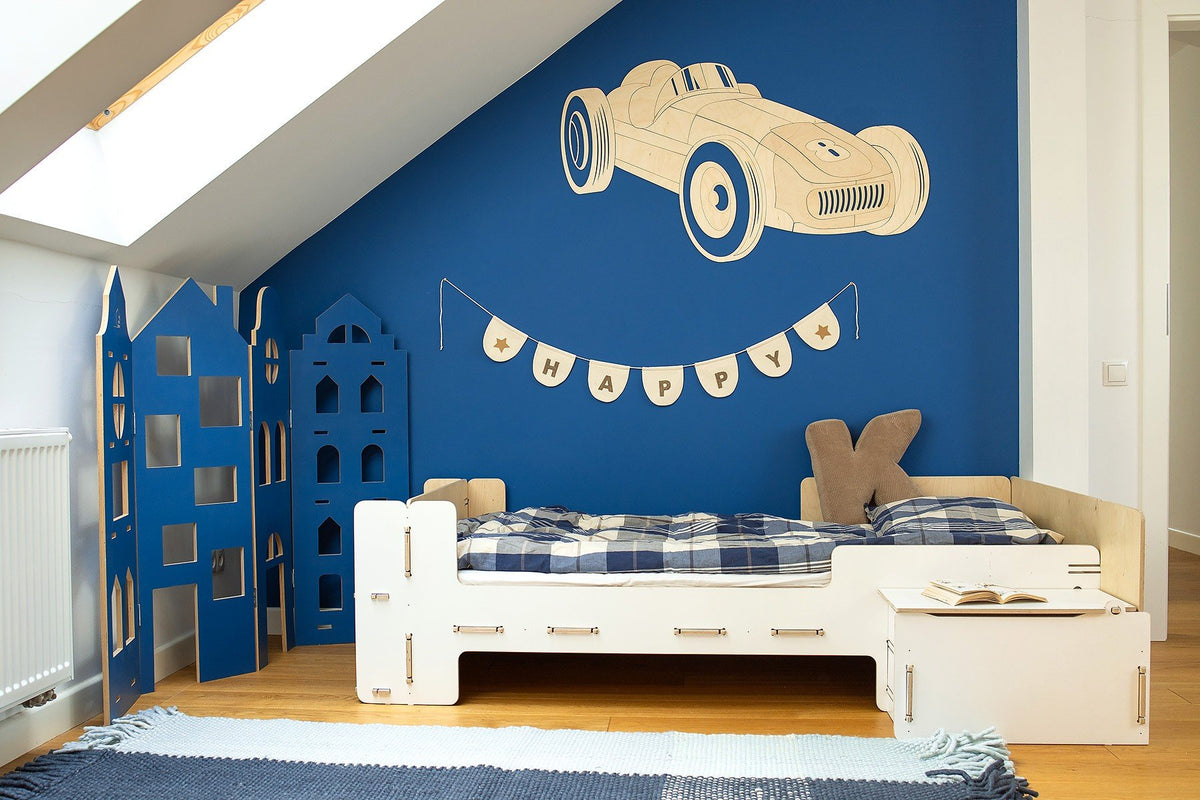 2. Blue-themed children's bedroom featuring wooden retro car wall decoration above bed