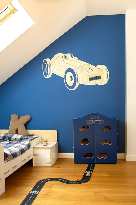 3. Wooden retro car wall decoration on blue wall in children's room with bed and play area