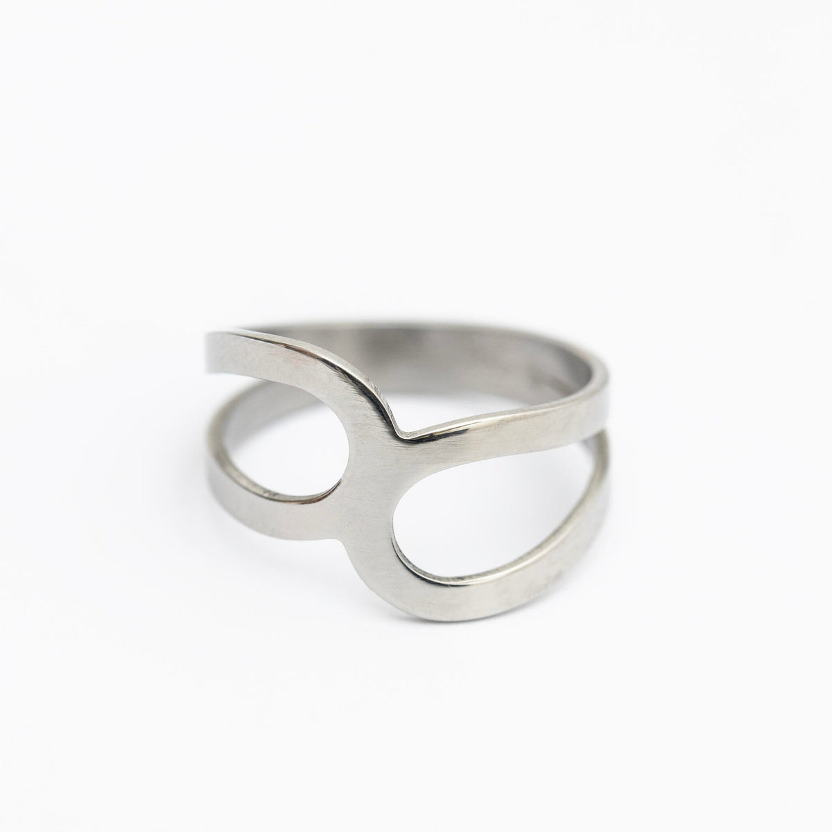 2. Stainless steel ring with polished surface and unique open design on white background