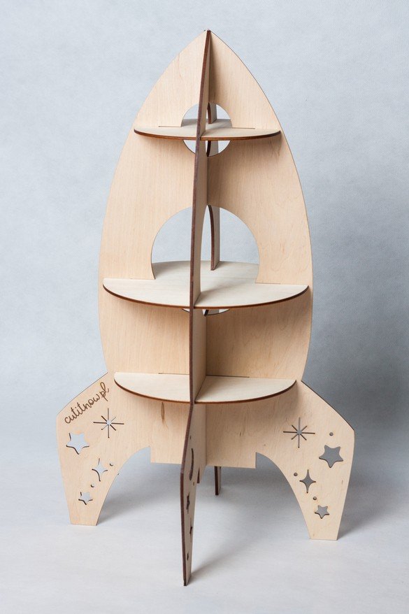 3. Studio shot of Cut It Now rocket-shaped wooden shelf with star and moon cut-outs on light background